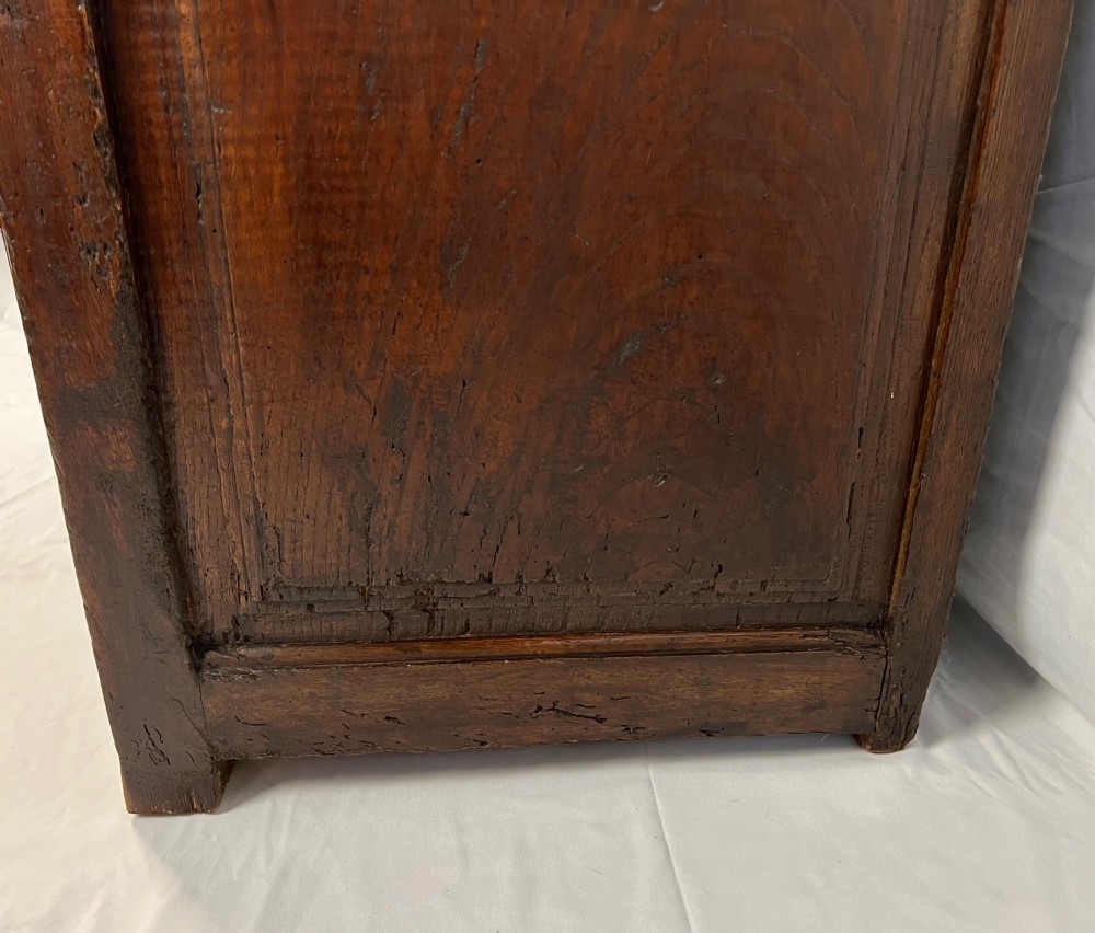 An 18th-century dark chestnut wood lavabo cabinet featuring a carved backboard mounted with a pewter cistern above a matching pewter basin. View X