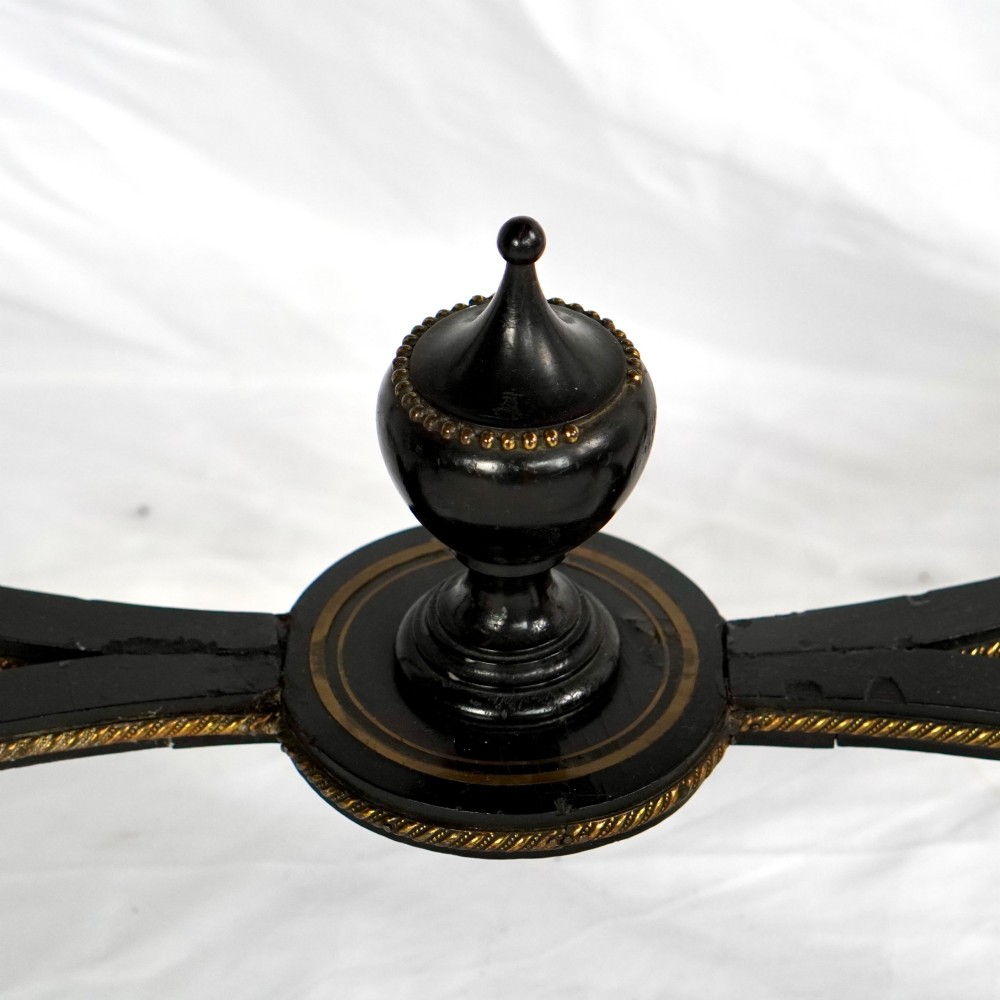 A French Napoleon III ebonised jardiniere stand featuring gilt highlights, inset painted porcelain plaques, a pierced brass gallery top, turned legs, and an arched lower stretcher. View V