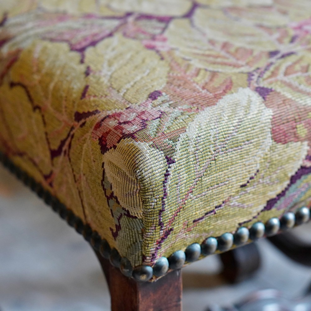 A pair of late 19th-century French walnut side chairs with high upholstered backs in a leafy green tapestry fabric and carved curved legs. View III