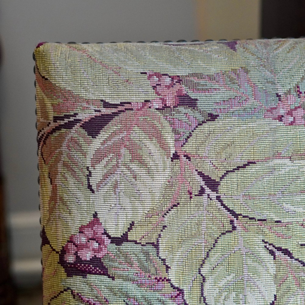 A pair of late 19th-century French walnut side chairs with high upholstered backs in a leafy green tapestry fabric and carved curved legs. View IV
