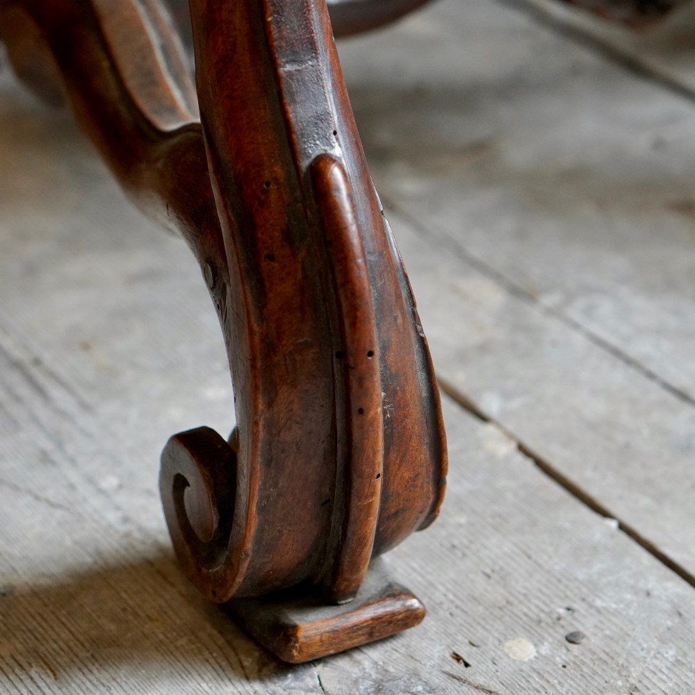 A pair of late 19th-century French walnut side chairs with high upholstered backs in a leafy green tapestry fabric and carved curved legs. View VIII