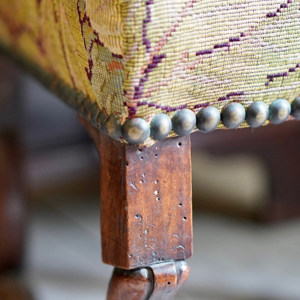 A pair of late 19th-century French walnut side chairs with high upholstered backs in a leafy green tapestry fabric and carved curved legs. View IX