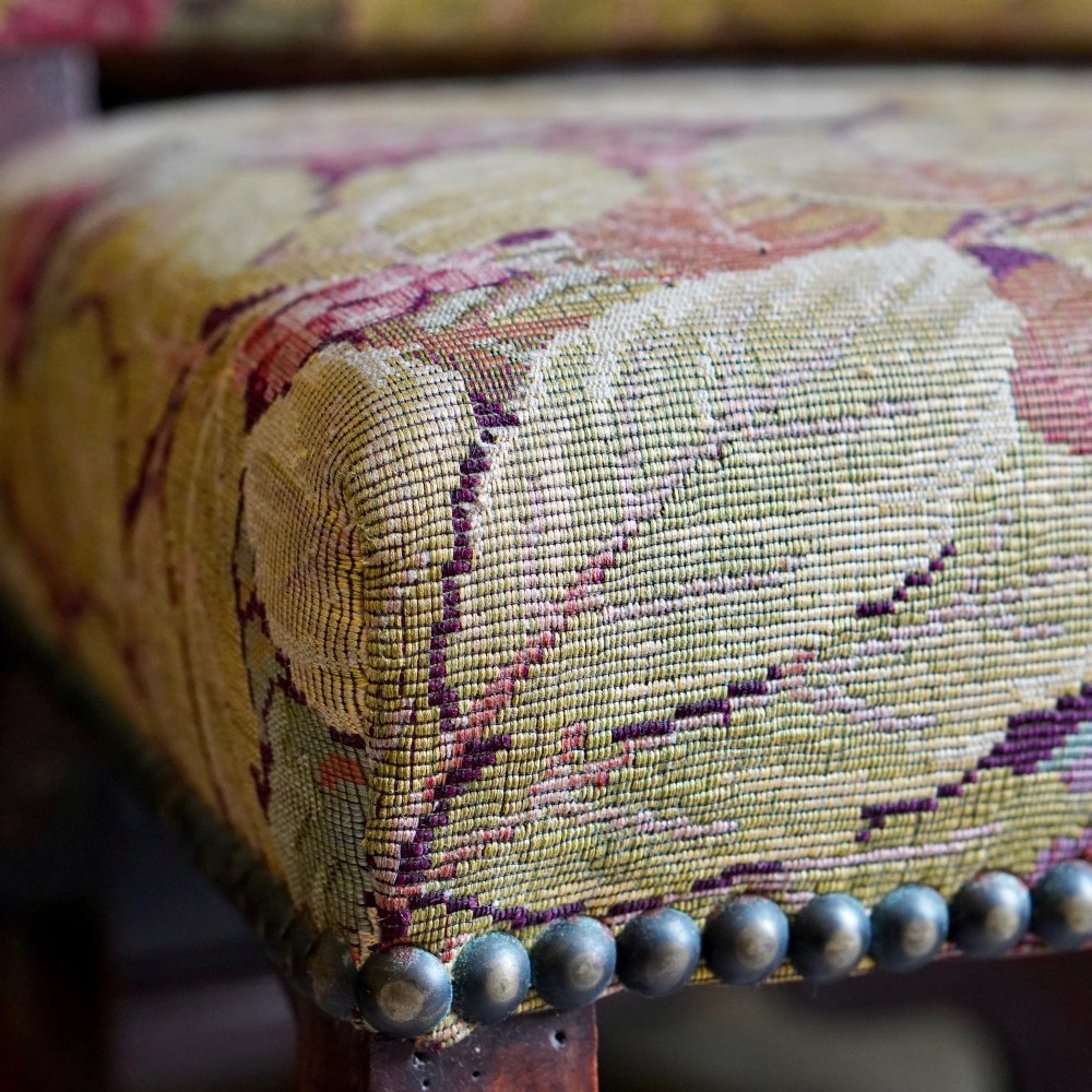 A pair of late 19th-century French walnut side chairs with high upholstered backs in a leafy green tapestry fabric and carved curved legs. View XI