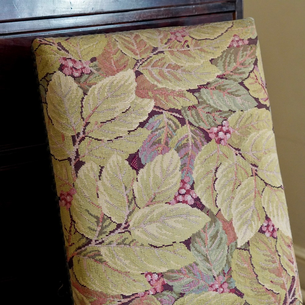 A pair of late 19th-century French walnut side chairs with high upholstered backs in a leafy green tapestry fabric and carved curved legs. View XII