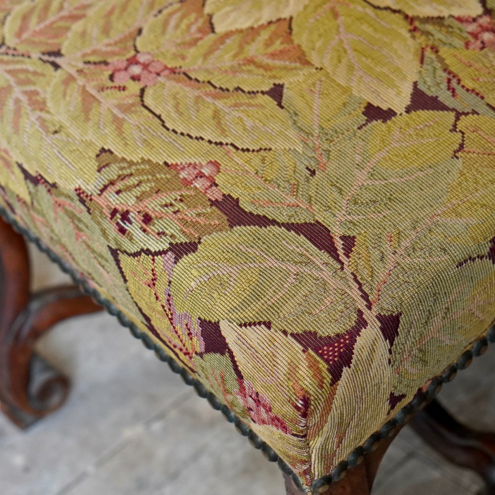 A pair of late 19th-century French walnut side chairs with high upholstered backs in a leafy green tapestry fabric and carved curved legs. View XIII