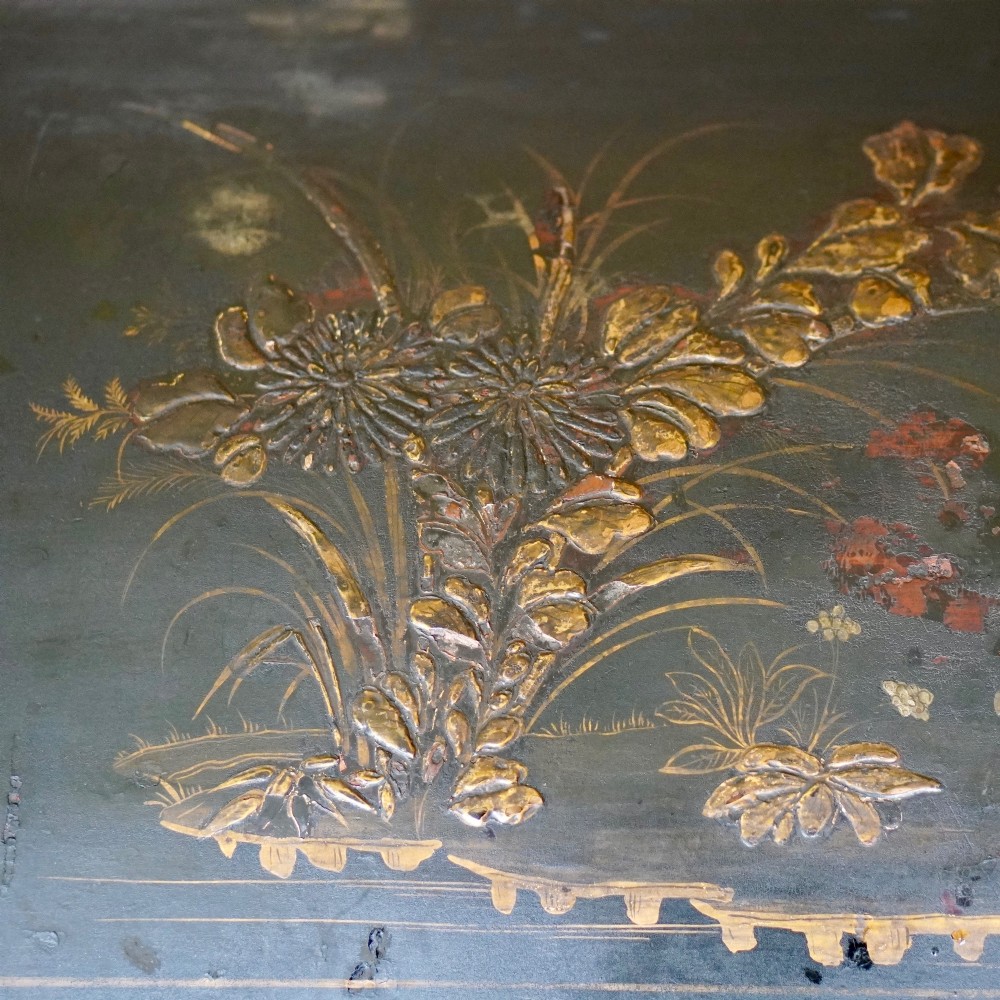 A 19th-century black lacquered domed storage trunk decorated with gilded chinoiserie landscape scenes and metal corner hardware. View II