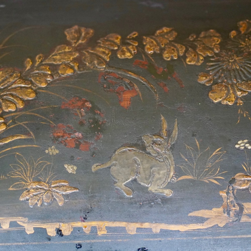 A 19th-century black lacquered domed storage trunk decorated with gilded chinoiserie landscape scenes and metal corner hardware. View III
