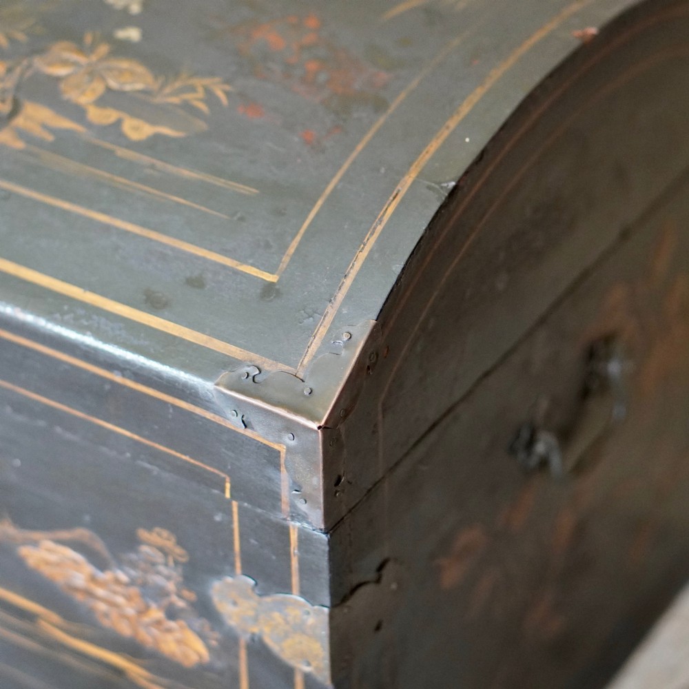 A 19th-century black lacquered domed storage trunk decorated with gilded chinoiserie landscape scenes and metal corner hardware. View VII