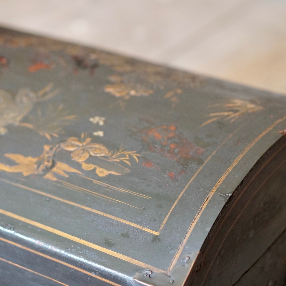 A 19th-century black lacquered domed storage trunk decorated with gilded chinoiserie landscape scenes and metal corner hardware. View VIII