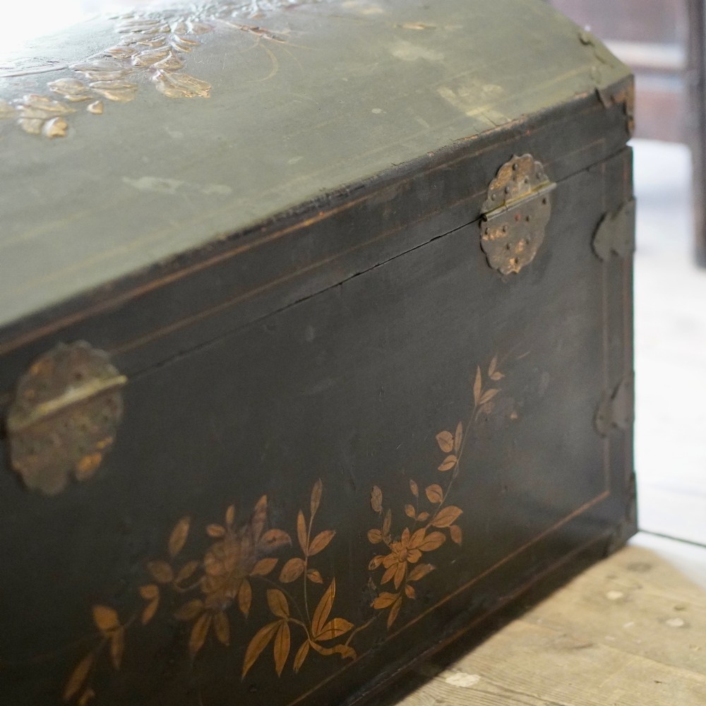 A 19th-century black lacquered domed storage trunk decorated with gilded chinoiserie landscape scenes and metal corner hardware. View XI