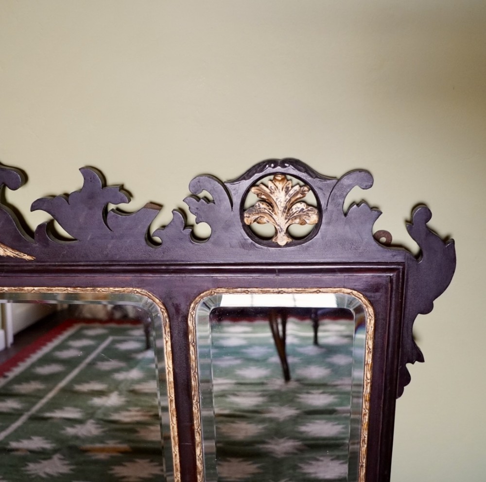 A dark mahogany triptych overmantel mirror with carved pierced fretwork, three mirror panels, and a gilded ho-ho bird cresting. View III