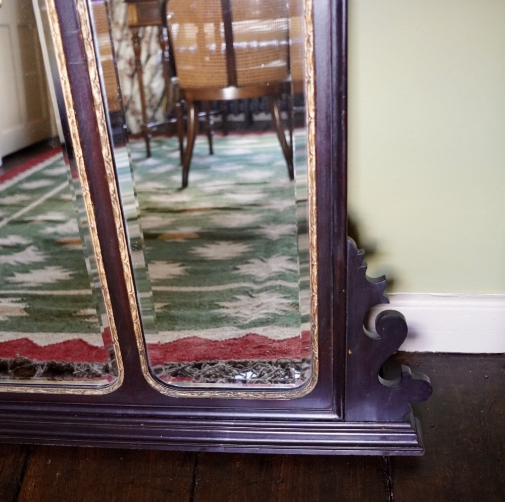 A dark mahogany triptych overmantel mirror with carved pierced fretwork, three mirror panels, and a gilded ho-ho bird cresting. View IV