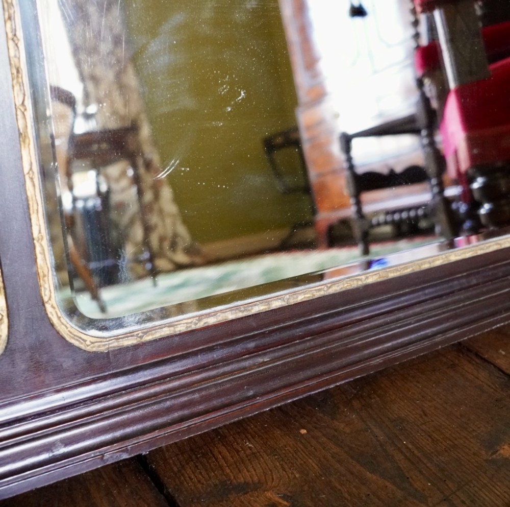 A dark mahogany triptych overmantel mirror with carved pierced fretwork, three mirror panels, and a gilded ho-ho bird cresting. View VI