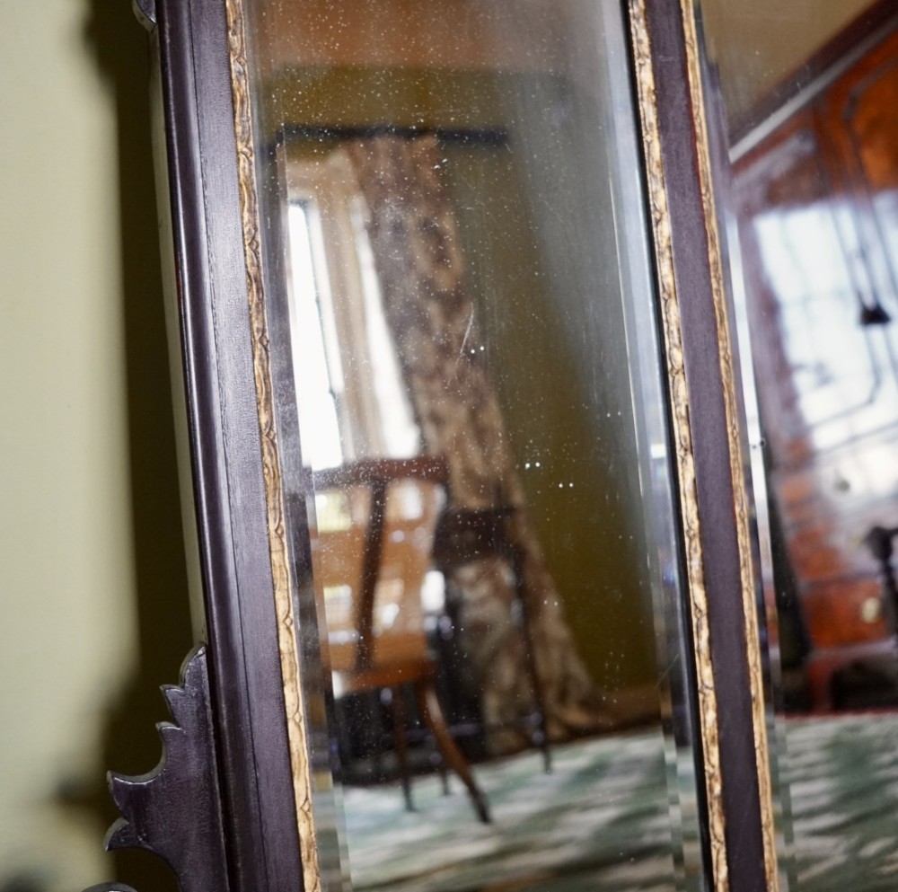 A dark mahogany triptych overmantel mirror with carved pierced fretwork, three mirror panels, and a gilded ho-ho bird cresting. View VII
