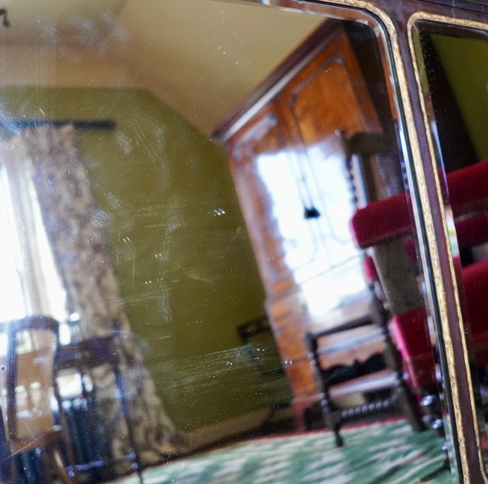 A dark mahogany triptych overmantel mirror with carved pierced fretwork, three mirror panels, and a gilded ho-ho bird cresting. View VIII