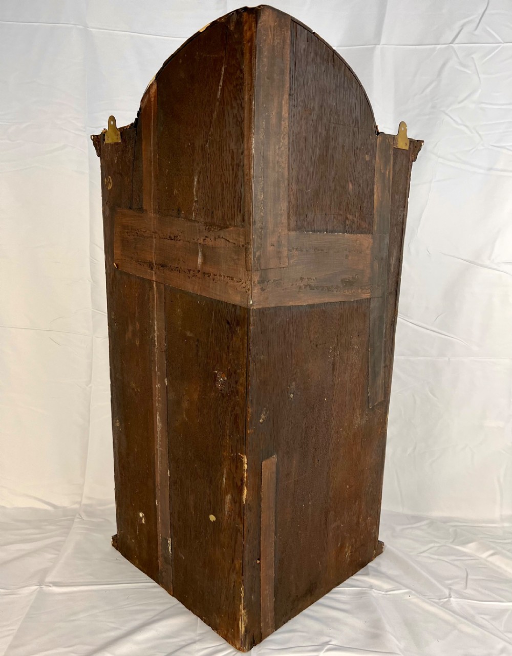 A Queen Anne walnut hanging corner cupboard featuring a double-moulded arched cornice, a mirrored door panel, and an integrated candle slide. View IX
