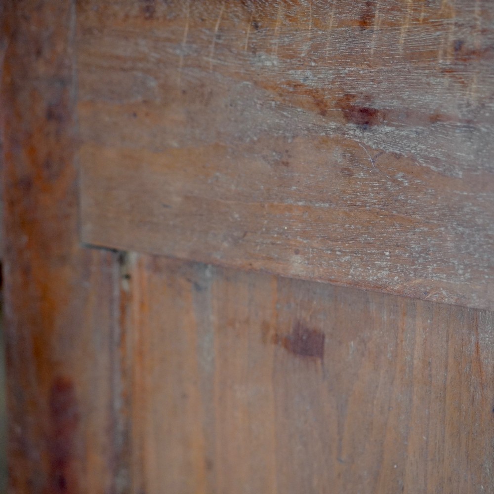 A Georgian mahogany hanging corner cupboard featuring an arched fielded panel door, brass H-hinges, key escutcheon, and a lower drawer. View X