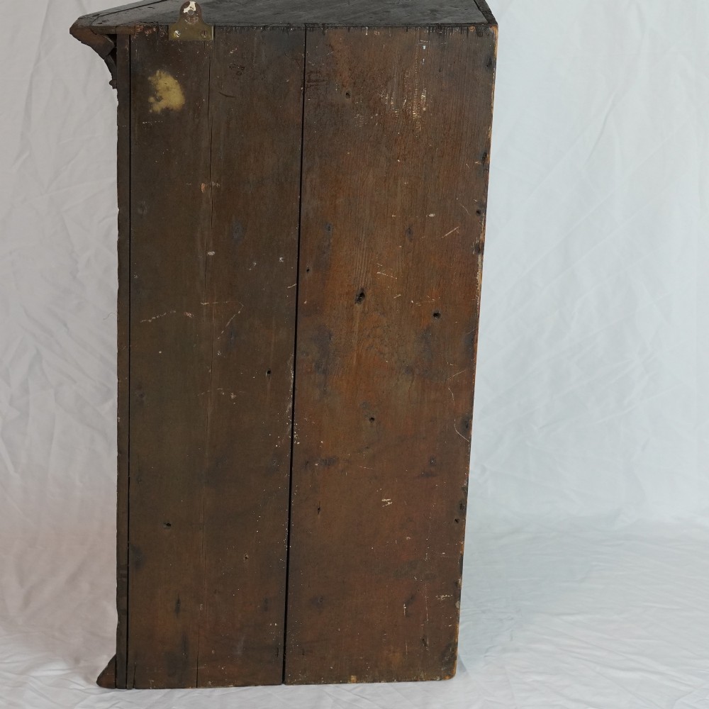 A Georgian mahogany hanging corner cupboard featuring an arched fielded panel door, brass H-hinges, key escutcheon, and a lower drawer. View XIII