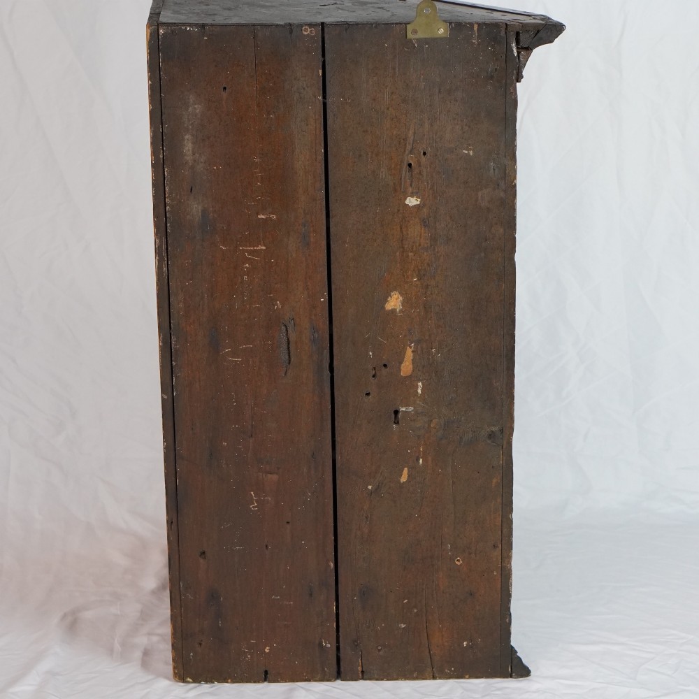 A Georgian mahogany hanging corner cupboard featuring an arched fielded panel door, brass H-hinges, key escutcheon, and a lower drawer. View XIV