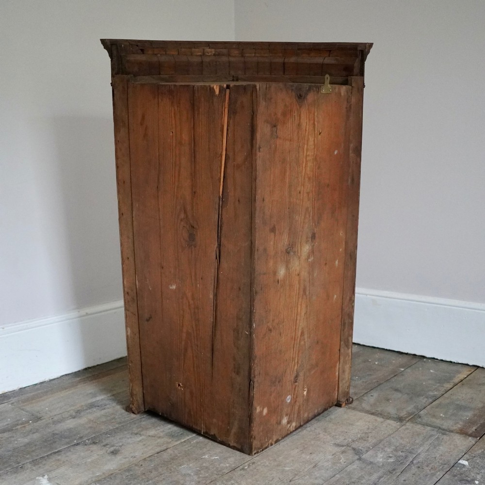 A George III bow front mahogany corner cabinet featuring polished plum pudding veneers, inlaid border stringing, and two curved doors. View XIII