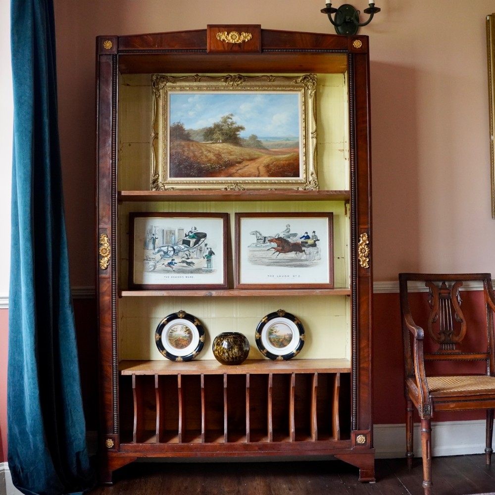 A nineteenth-century French Empire style rosewood open bookcase featuring brass mounts and adjustable shelves above vertical dividers. View II