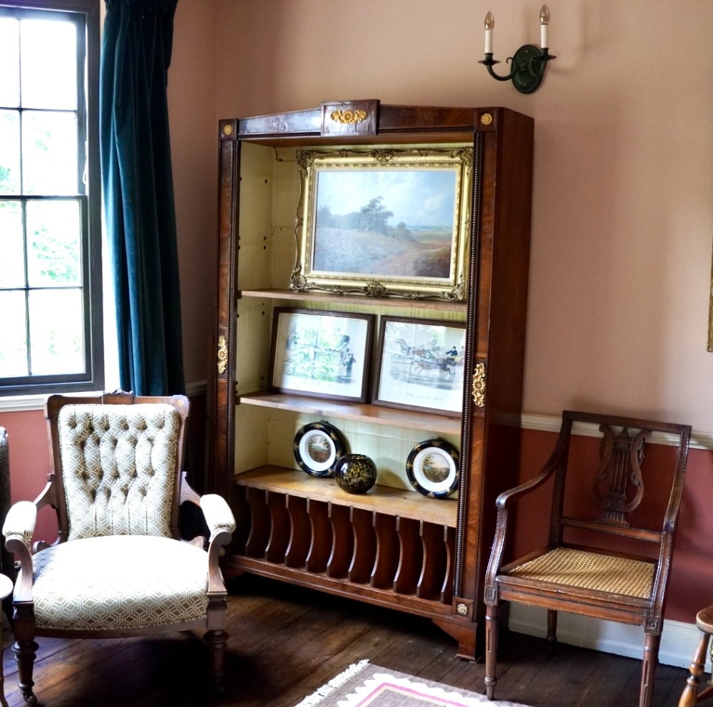 A nineteenth-century French Empire style rosewood open bookcase featuring brass mounts and adjustable shelves above vertical dividers. View IX