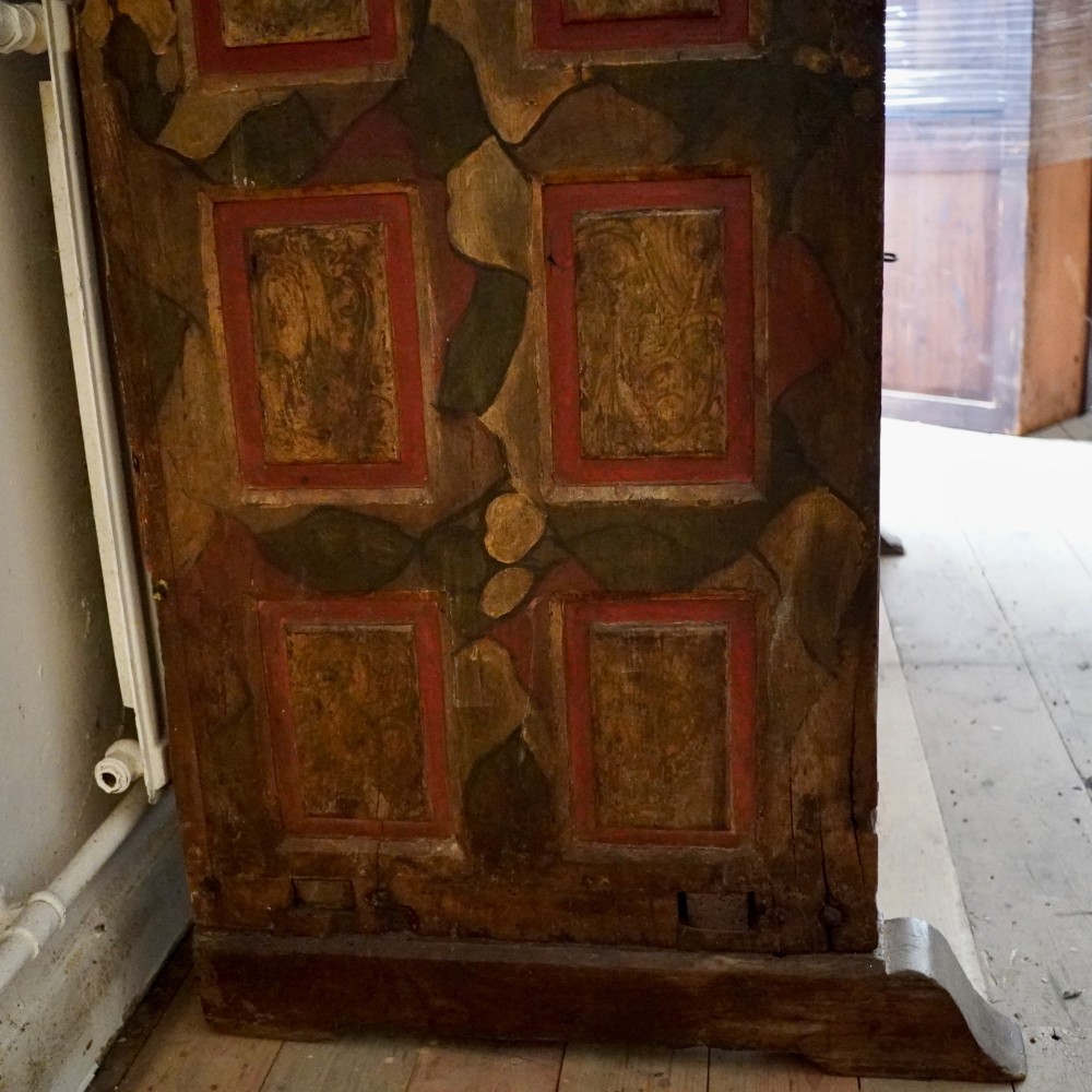 A tall seventeenth-century Spanish oak press cupboard featuring double upper and lower doors decorated with geometric raised panels and painted polychrome geometric patterns. View VII