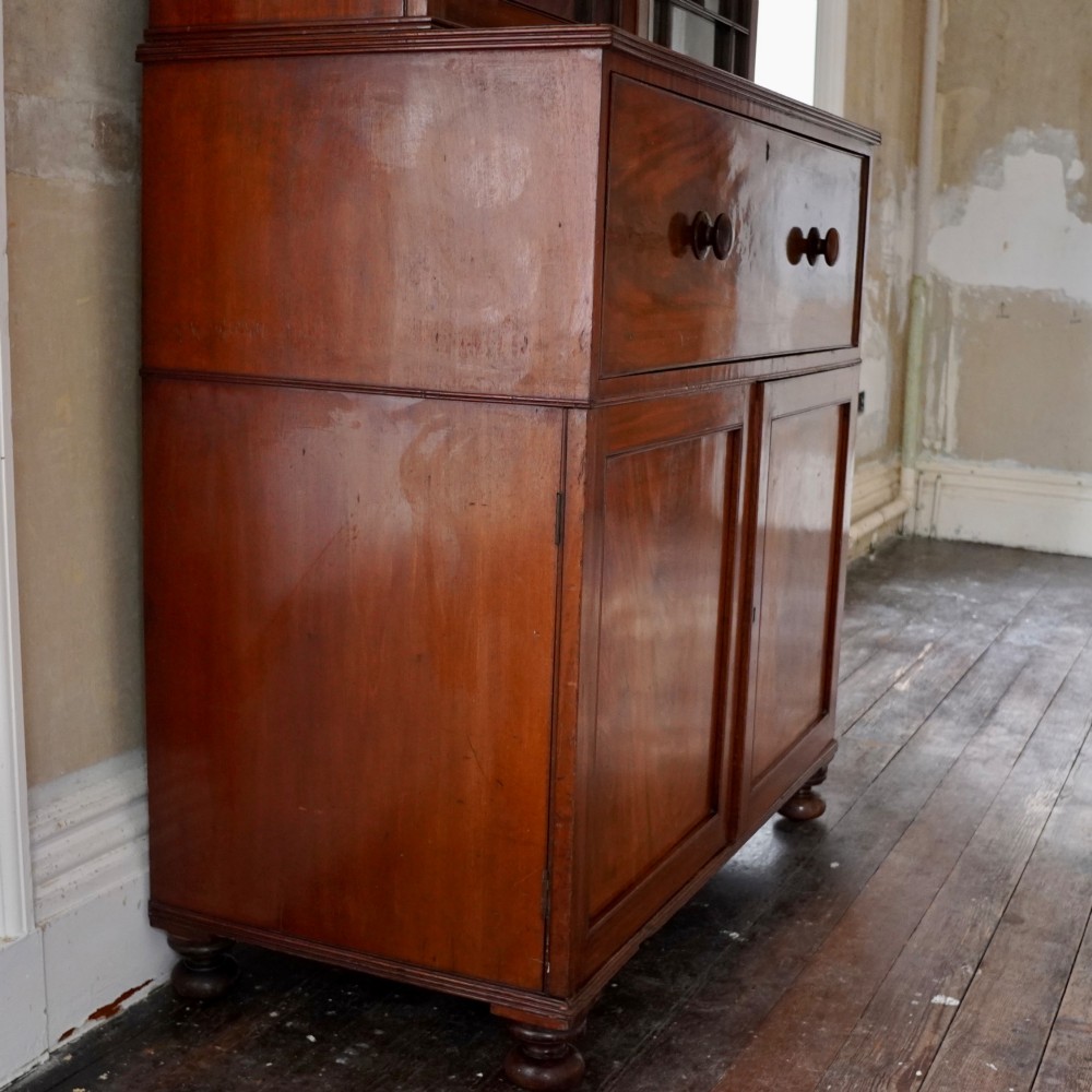 A nineteenth-century George IV mahogany secretaire bookcase with glazed upper doors featuring gothic tracery and a drop-down desk drawer revealing a fitted interior. View VII