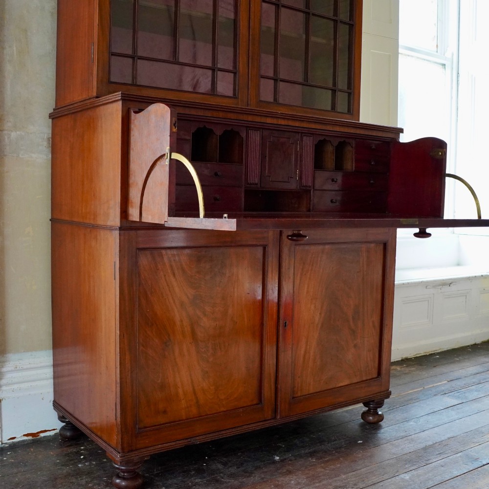 A nineteenth-century George IV mahogany secretaire bookcase with glazed upper doors featuring gothic tracery and a drop-down desk drawer revealing a fitted interior. View VIII