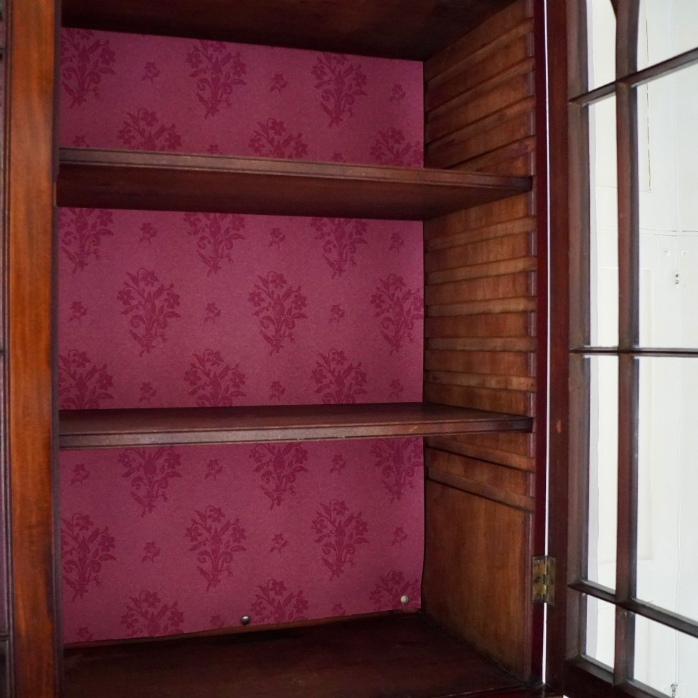 A nineteenth-century George IV mahogany secretaire bookcase with glazed upper doors featuring gothic tracery and a drop-down desk drawer revealing a fitted interior. View XIII