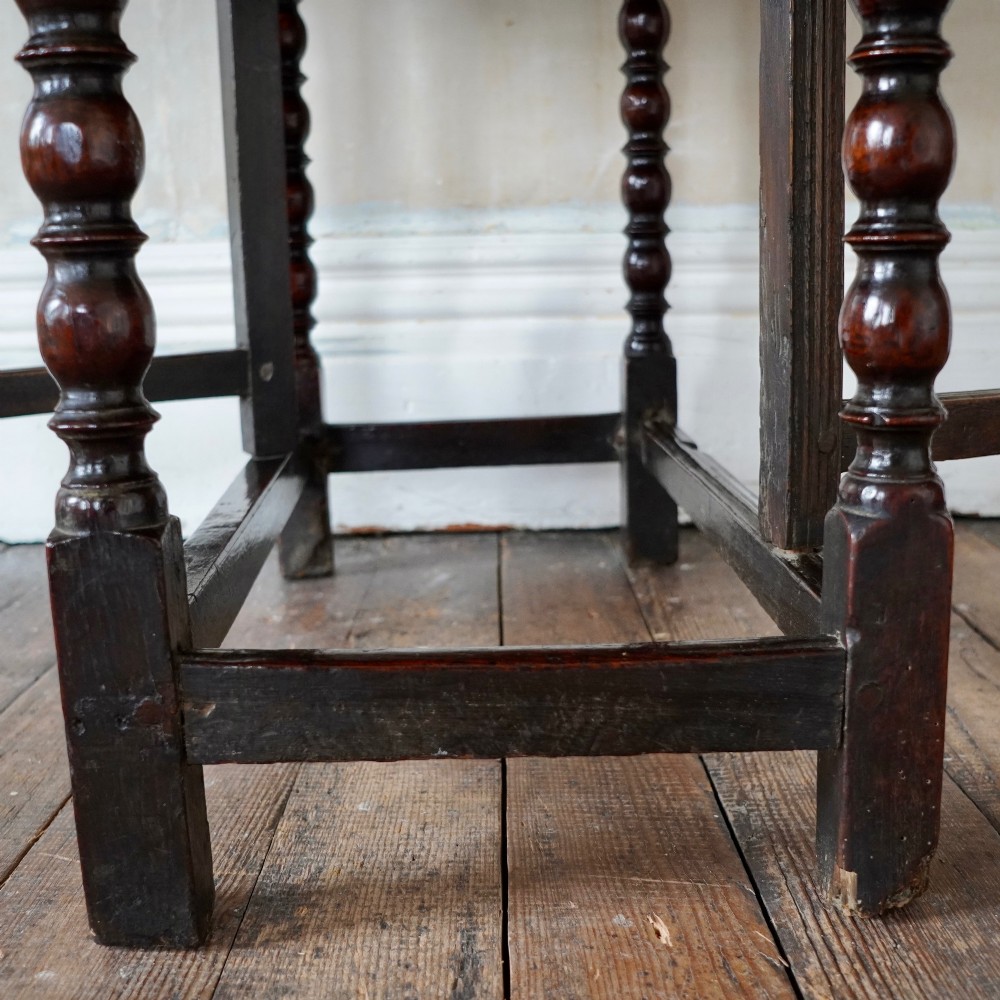 A dark brown antique oak gateleg drop-leaf table with turned legs and an oval top. View X