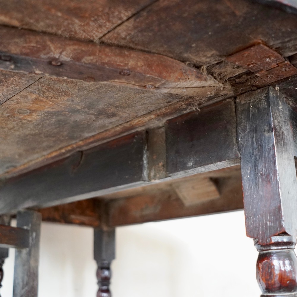 A dark brown antique oak gateleg drop-leaf table with turned legs and an oval top. View XI