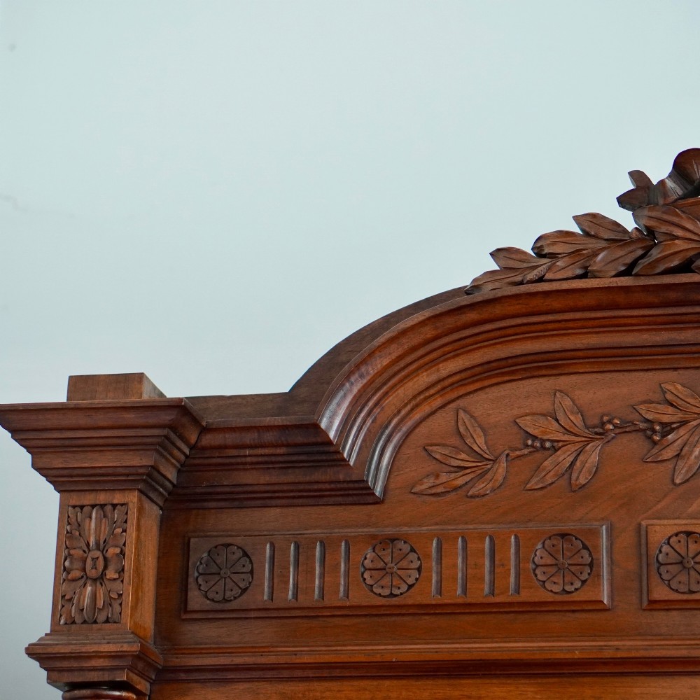 A tall 19th-century Continental open wooden bookcase featuring an ornate carved pediment, fluted side columns, panelled back, and multiple adjustable shelves. View III