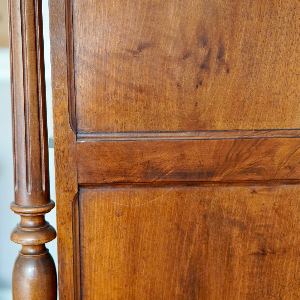 A tall 19th-century Continental open wooden bookcase featuring an ornate carved pediment, fluted side columns, panelled back, and multiple adjustable shelves. View V