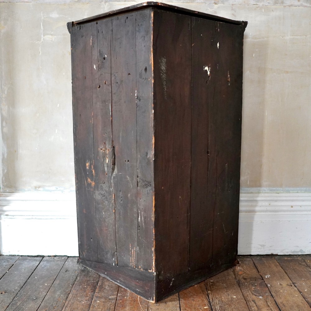 Mid-18th century Georgian mahogany hanging corner cupboard featuring an arched panelled door, brass hardware, and fluted pilasters. View VIII