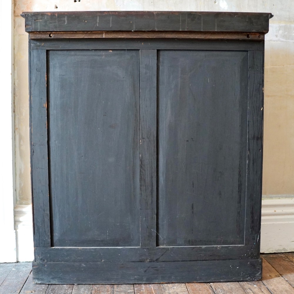 An antique William IV rosewood open bookcase featuring two adjustable shelves, a solid plinth base, and carved scroll capitals atop side pilasters. View XIV
