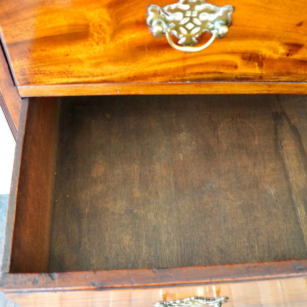A late 18th-century George III mahogany chest on chest featuring brass swan-neck handles, keyhole escutcheons, dentil moulding, and bracket feet. View III