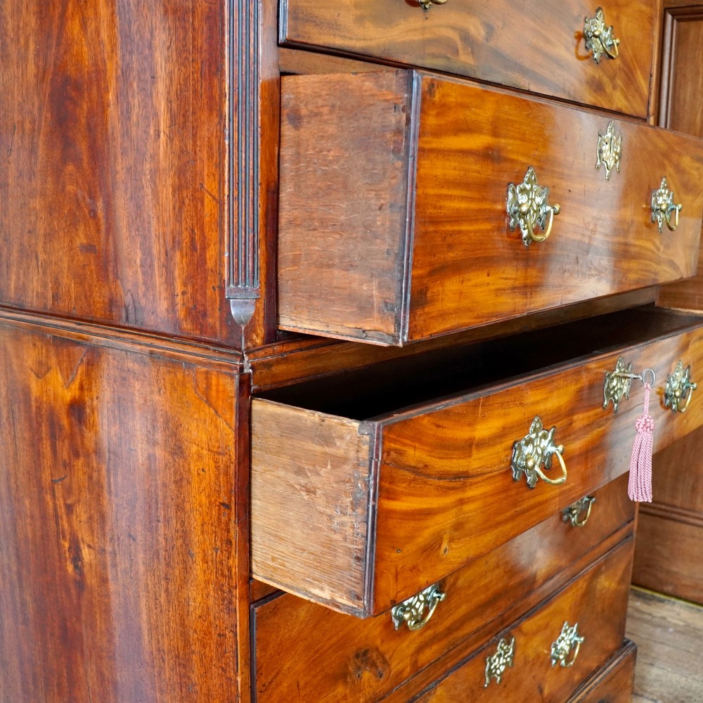 A late 18th-century George III mahogany chest on chest featuring brass swan-neck handles, keyhole escutcheons, dentil moulding, and bracket feet. View IV