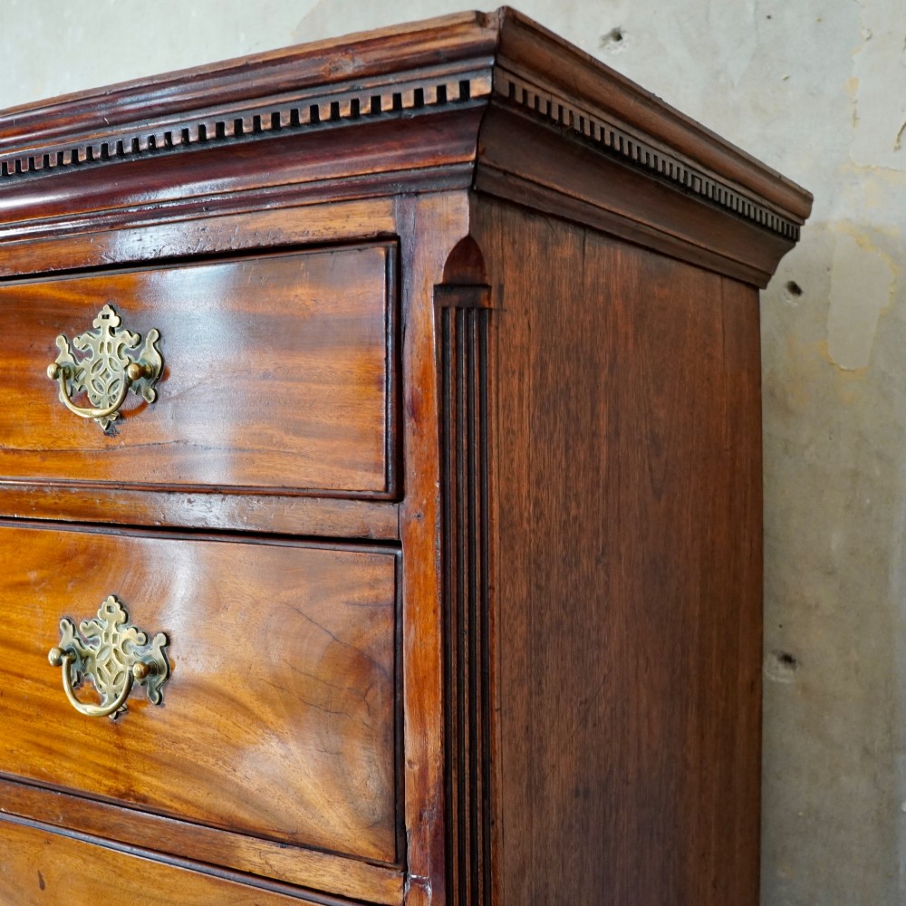 A late 18th-century George III mahogany chest on chest featuring brass swan-neck handles, keyhole escutcheons, dentil moulding, and bracket feet. View VI