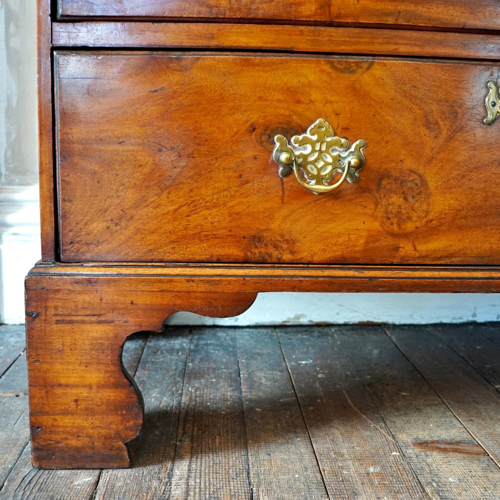 A late 18th-century George III mahogany chest on chest featuring brass swan-neck handles, keyhole escutcheons, dentil moulding, and bracket feet. View VII