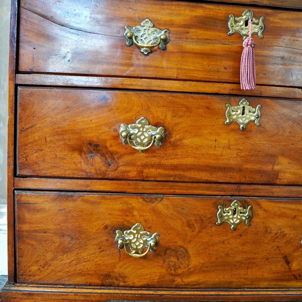 A late 18th-century George III mahogany chest on chest featuring brass swan-neck handles, keyhole escutcheons, dentil moulding, and bracket feet. View VIII