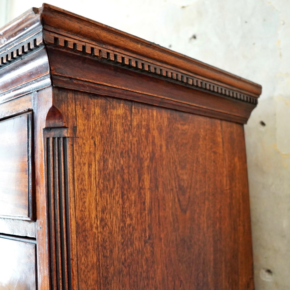 A late 18th-century George III mahogany chest on chest featuring brass swan-neck handles, keyhole escutcheons, dentil moulding, and bracket feet. View XII
