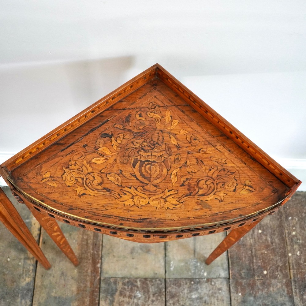 A pair of 18th-century triangular corner tables featuring detailed floral marquetry top surfaces, pierced friezes, tapering legs, and brass galleries. View IV