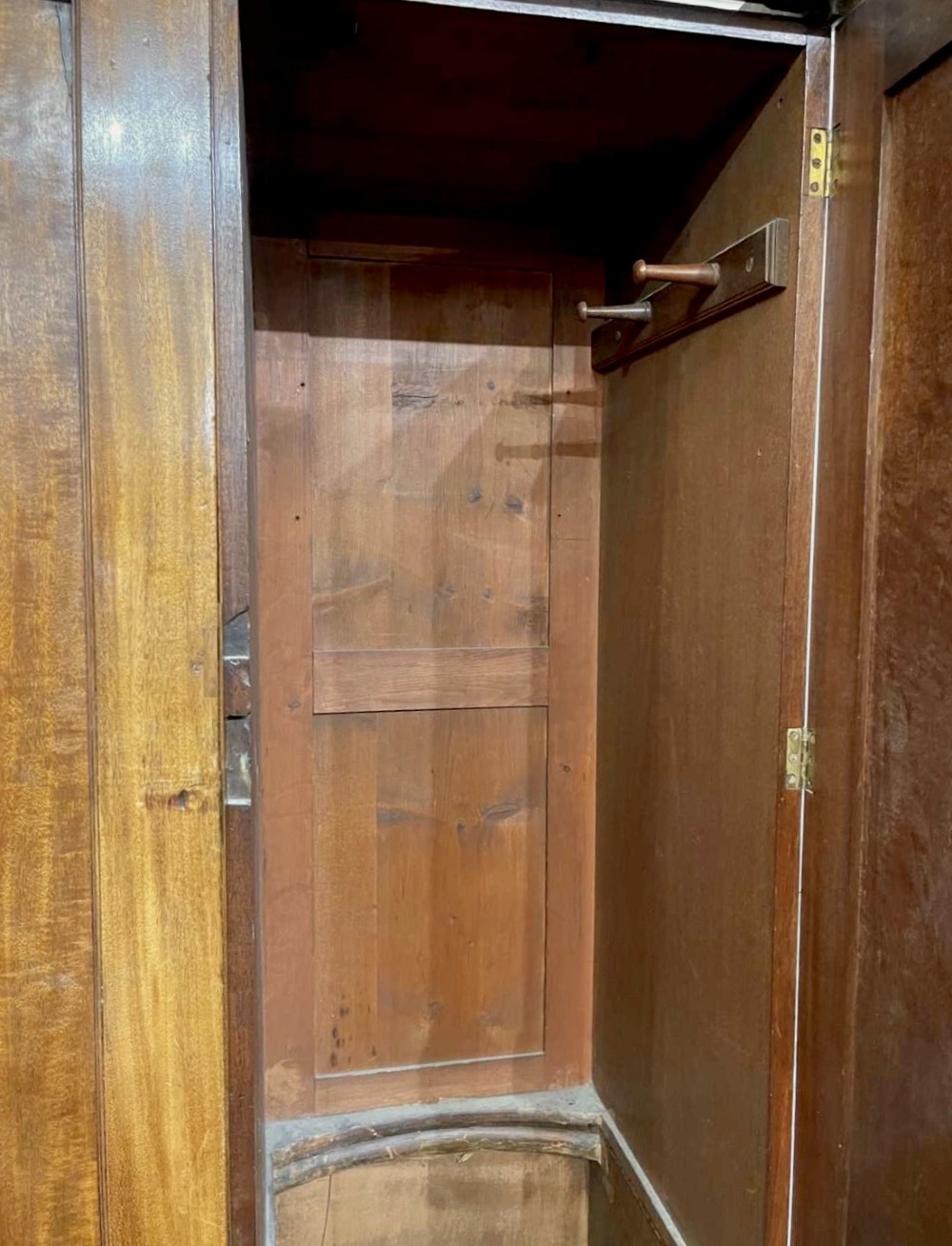 A large George III mahogany breakfront linen press wardrobe featuring central panelled doors above drawers, flanked by side cupboards on bracket feet. View VII