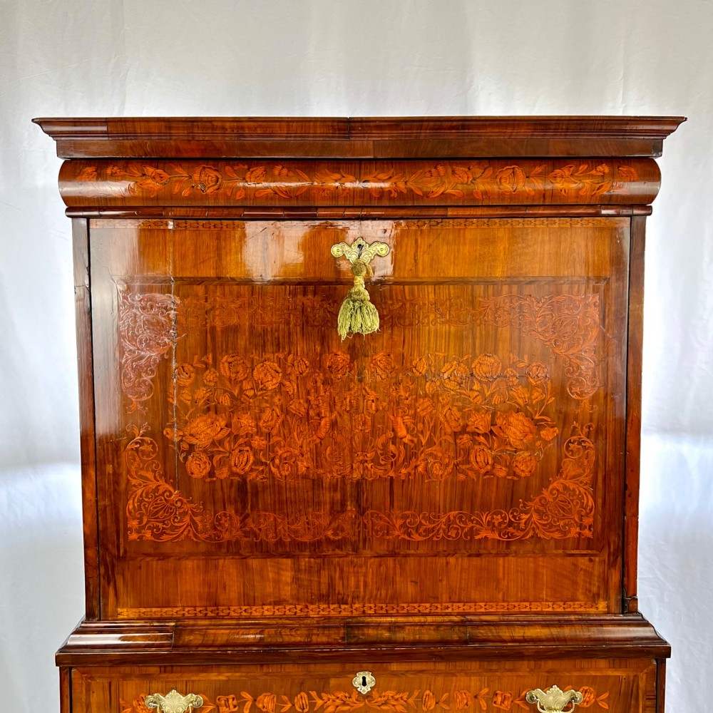 A tall Georgian walnut escritoire bureau featuring floral marquetry inlay on the fall-front flap and lower drawers with brass drop handles. View II