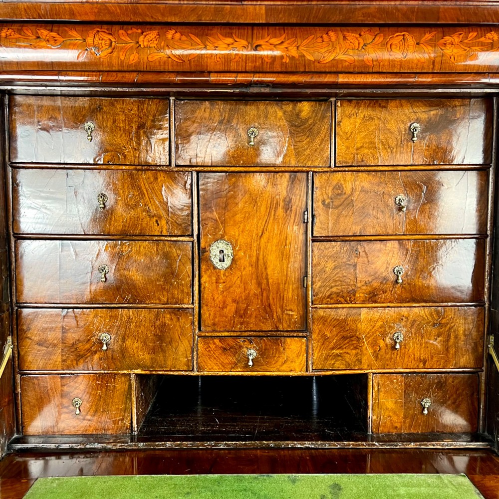 A tall Georgian walnut escritoire bureau featuring floral marquetry inlay on the fall-front flap and lower drawers with brass drop handles. View VII