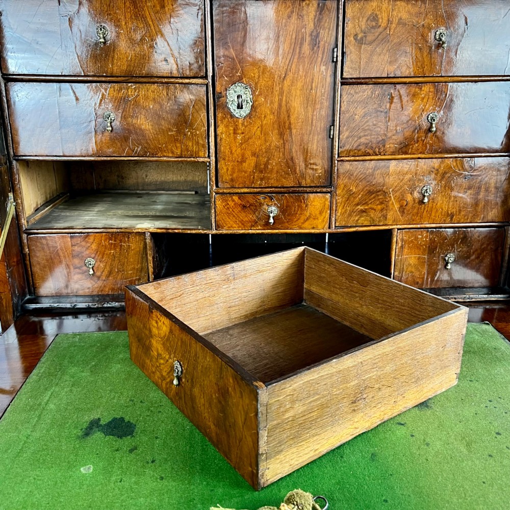 A tall Georgian walnut escritoire bureau featuring floral marquetry inlay on the fall-front flap and lower drawers with brass drop handles. View IX