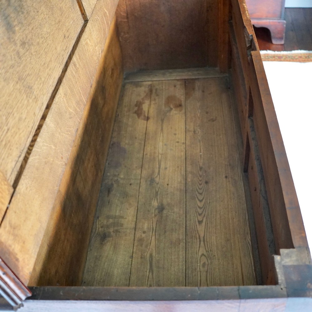 A Georgian oak and mahogany crossbanded Lancashire mule chest with brass handles and bracket feet. View II