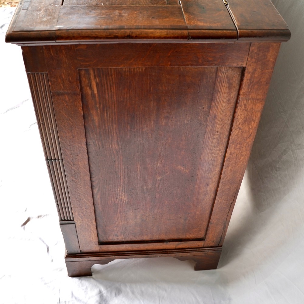 A Georgian oak and mahogany crossbanded Lancashire mule chest with brass handles and bracket feet. View V