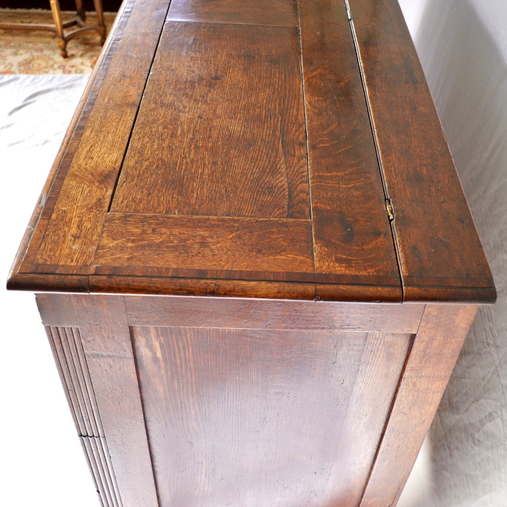 A Georgian oak and mahogany crossbanded Lancashire mule chest with brass handles and bracket feet. View IX